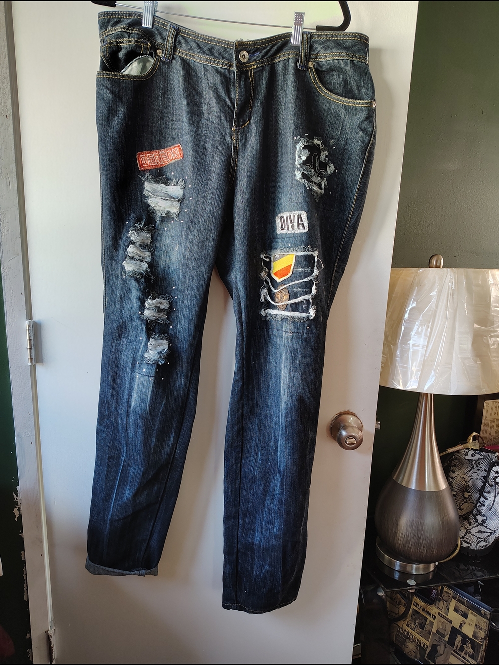 Dark Wash Deréon distressed jeans featuring patchwork and embellishments. Y2K